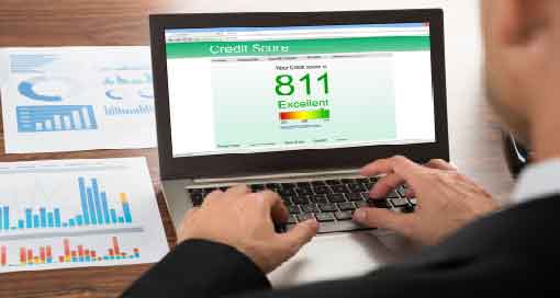 person checking credit score on laptop